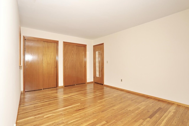 19 Verona Ct, New City, NY 10956 - unfurnished bedroom with two closets, light wood-type flooring, and baseboards
