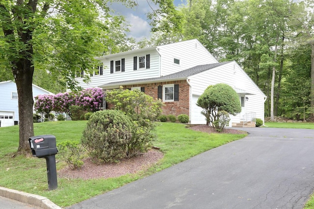 19 Verona Ct, New City, NY 10956 - view of front of house with an attached garage, brick siding, driveway, and a front lawn