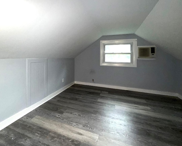 284 Titusville Rd, Poughkeepsie, NY 12603 - additional living space with a wall unit AC, dark wood finished floors, baseboards, and vaulted ceiling