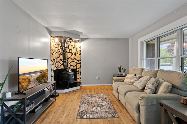 12 Debragga Ave, East Moriches, NY 11940 - living room featuring light wood-type flooring, a wood stove, and baseboards