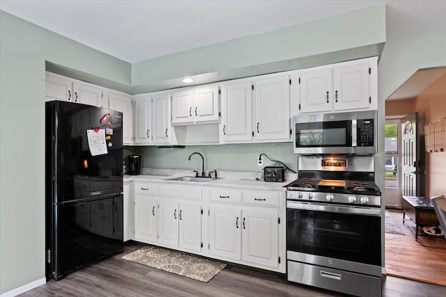 12 Debragga Ave, East Moriches, NY 11940 - kitchen featuring appliances with stainless steel finishes, a sink, white cabinets, and light countertops