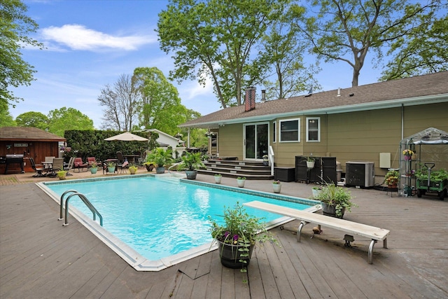 12 Debragga Ave, East Moriches, NY 11940 - swimming pool featuring a deck, a diving board, and entry steps