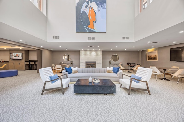 555 W 23rd St Unit S3Q, New York Manhattan, NY 10011 - living area featuring a towering ceiling, carpet, a fireplace, and recessed lighting