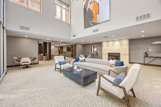 555 W 23rd St Unit S3Q, New York Manhattan, NY 10011 - carpeted living area with baseboards, a towering ceiling, a fireplace, and recessed lighting