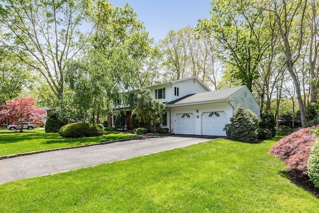 18 Stuyvesant Cir E, East Setauket, NY 11733 - view of front of home with a garage, driveway, and a front yard