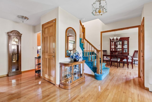 18 Stuyvesant Cir E, East Setauket, NY 11733 - foyer entrance with a chandelier, light wood-type flooring, stairs, and baseboards