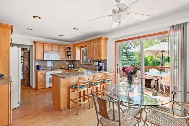 18 Stuyvesant Cir E, East Setauket, NY 11733 - kitchen with white appliances, a peninsula, light wood-style floors, decorative backsplash, and recessed lighting
