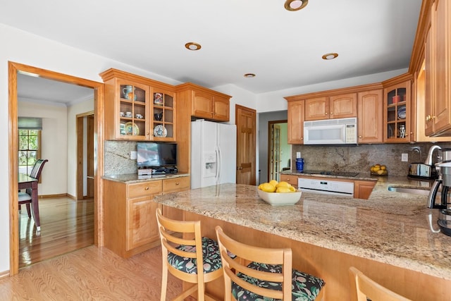 18 Stuyvesant Cir E, East Setauket, NY 11733 - kitchen with white appliances, a sink, a peninsula, light stone countertops, and recessed lighting