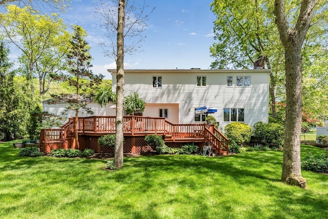 18 Stuyvesant Cir E, East Setauket, NY 11733 - rear view of house featuring a chimney, a wooden deck, and a lawn