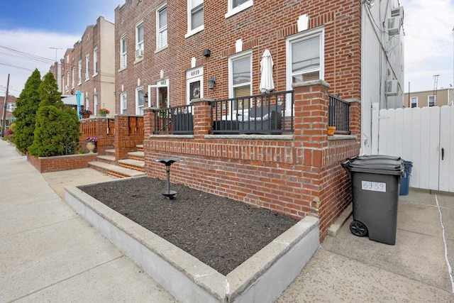 69-59 74th St, Middle Village, NY 11379 - view of side of home featuring brick siding and cooling unit
