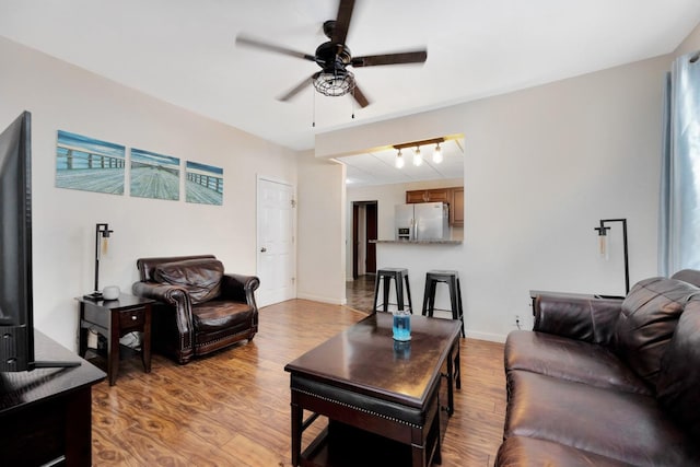 69-59 74th St, Middle Village, NY 11379 - living room with ceiling fan, light wood-style flooring, and baseboards