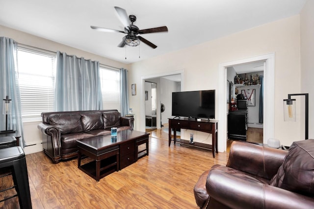 69-59 74th St, Middle Village, NY 11379 - living room with ceiling fan, light wood-style flooring, and a baseboard heating unit