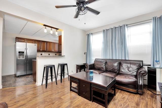 69-59 74th St, Middle Village, NY 11379 - living room featuring a ceiling fan, baseboards, and light wood-type flooring