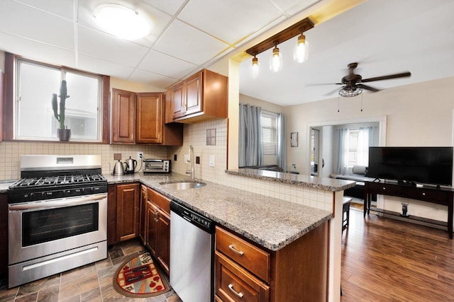 69-59 74th St, Middle Village, NY 11379 - kitchen featuring stainless steel appliances, a sink, a peninsula, and light stone counters