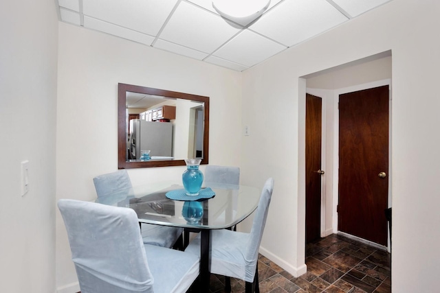 69-59 74th St, Middle Village, NY 11379 - dining area with stone finish floors, baseboards, and a drop ceiling
