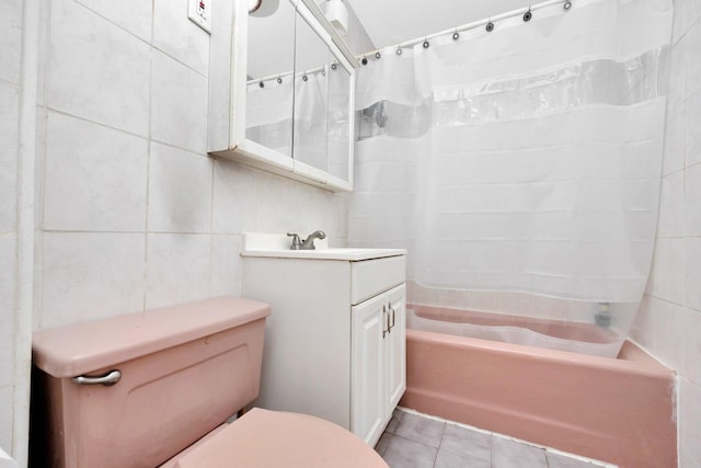 69-59 74th St, Middle Village, NY 11379 - full bath with tile walls, shower / bath combo, toilet, vanity, and tile patterned flooring