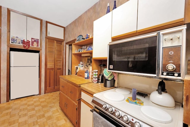 69-59 74th St, Middle Village, NY 11379 - kitchen with white appliances, open shelves, white cabinets, and wood counters