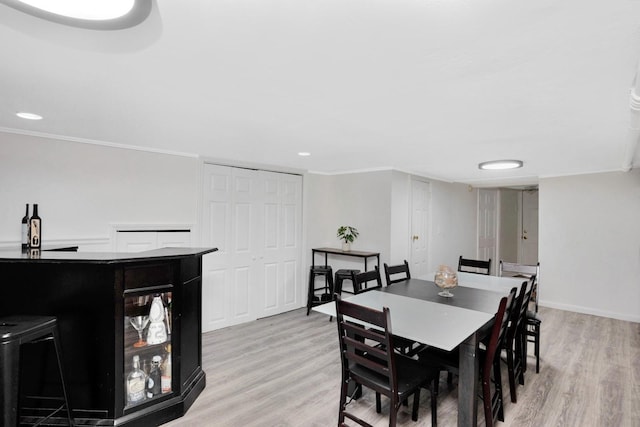 69-59 74th St, Middle Village, NY 11379 - dining room featuring light wood-style flooring, ornamental molding, recessed lighting, and baseboards