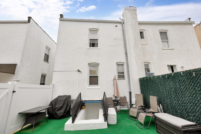 69-59 74th St, Middle Village, NY 11379 - rear view of property featuring fence and stucco siding