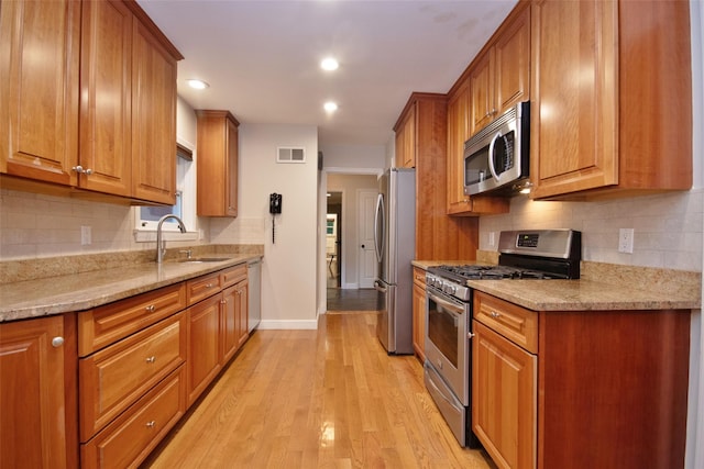 4 Southview Rd, Chappaqua, NY 10514 - kitchen with appliances with stainless steel finishes, a sink, brown cabinetry, baseboards, and decorative backsplash