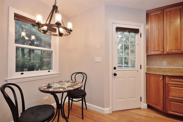 4 Southview Rd, Chappaqua, NY 10514 - dining room with a chandelier, light wood-type flooring, and baseboards