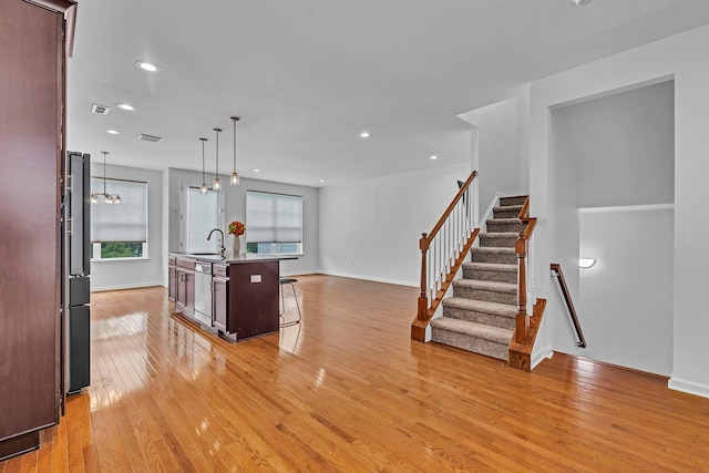 37 Lindentree Ln, Middletown, NY 10940 - kitchen with a sink, light wood-style floors, a kitchen breakfast bar, freestanding refrigerator, and recessed lighting