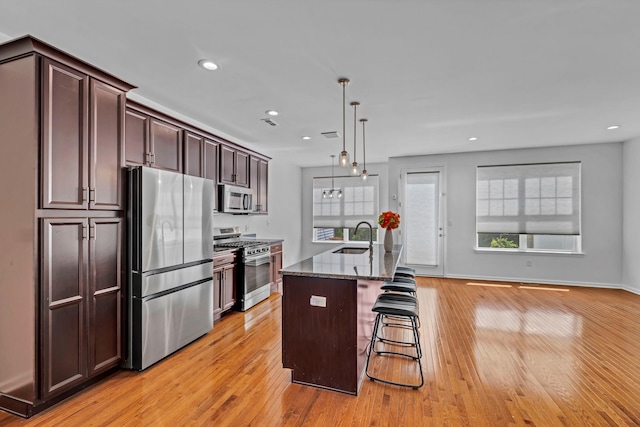 37 Lindentree Ln, Middletown, NY 10940 - kitchen with stainless steel appliances, light wood-style floors, a sink, dark stone countertops, and recessed lighting