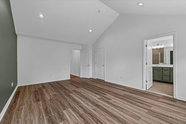 37 Lindentree Ln, Middletown, NY 10940 - unfurnished bedroom with wood finished floors, high vaulted ceiling, baseboards, recessed lighting, and connected bathroom