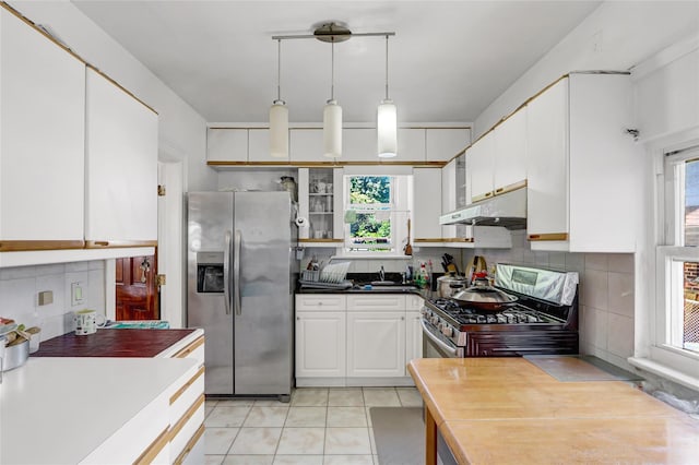 34-08 Murray Ln, Flushing, NY 11354 - kitchen featuring stainless steel appliances, under cabinet range hood, plenty of natural light, and white cabinets