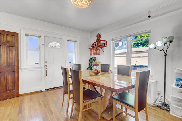 34-08 Murray Ln, Flushing, NY 11354 - dining area featuring light wood-style floors, ornamental molding, and a chandelier