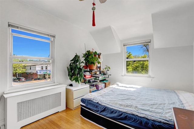 34-08 Murray Ln, Flushing, NY 11354 - bedroom featuring radiator heating unit, light wood-style floors, and a ceiling fan