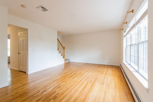 20 S St S, Highland Falls, NY 10928 - empty room featuring baseboard heating, light wood-type flooring, stairs, and healthy amount of natural light