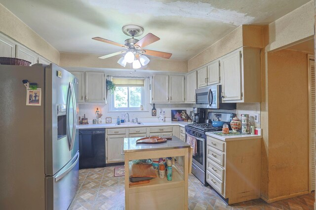 2 Mohican Rd, Newburgh, NY 12550 - kitchen featuring appliances with stainless steel finishes, a sink, light countertops, ceiling fan, and a center island