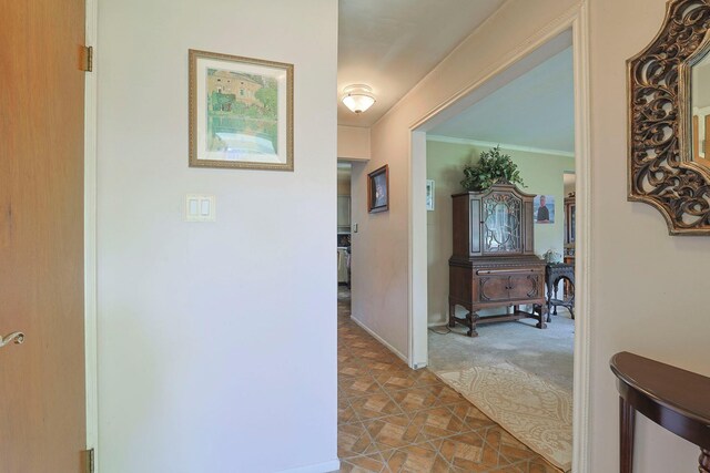 2 Mohican Rd, Newburgh, NY 12550 - corridor featuring carpet floors, tile patterned flooring, ornamental molding, and baseboards