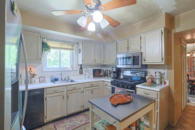 2 Mohican Rd, Newburgh, NY 12550 - kitchen with stainless steel appliances, a sink, a ceiling fan, and light countertops