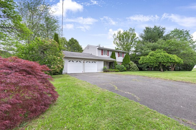 2 Mohican Rd, Newburgh, NY 12550 - view of front of property featuring a garage, driveway, and a front yard