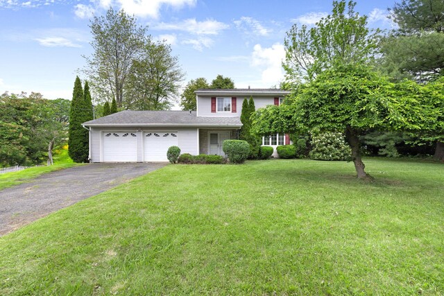 2 Mohican Rd, Newburgh, NY 12550 - view of front of home featuring an attached garage, asphalt driveway, and a front lawn