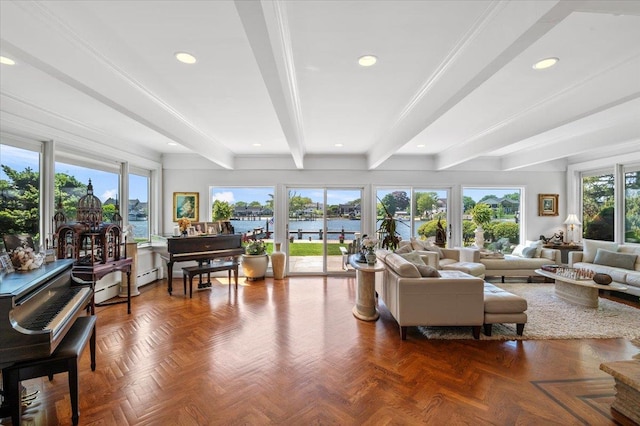 living area with beam ceiling, a water view, and recessed lighting