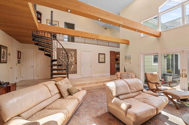 living area featuring a high ceiling, stairs, recessed lighting, plenty of natural light, and baseboards