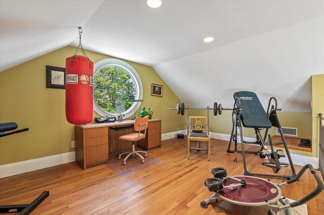 exercise room with lofted ceiling, light wood finished floors, baseboards, and recessed lighting