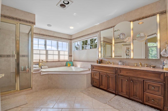 bathroom with healthy amount of natural light, a garden tub, tile patterned flooring, and a shower stall