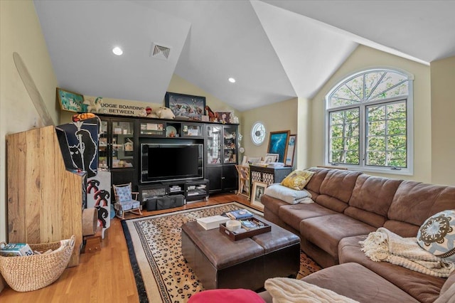 living area featuring vaulted ceiling, wood finished floors, and recessed lighting
