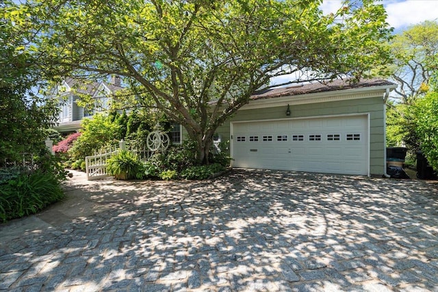 garage featuring asphalt driveway