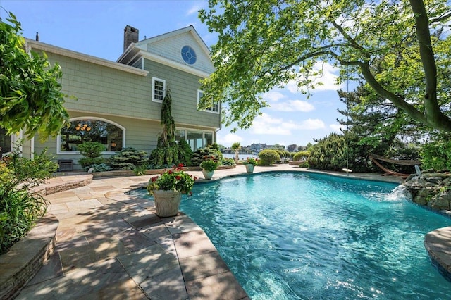outdoor pool with a patio area