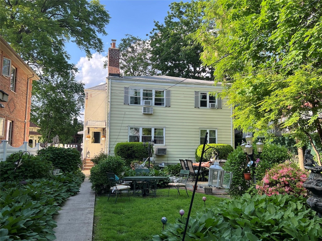 196-19 42nd Rd, Flushing, NY 11358 - back of property with a chimney and a lawn