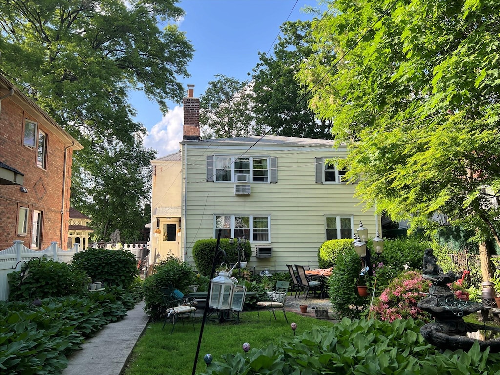 196-19 42nd Rd, Flushing, NY 11358 - back of property with a chimney, a patio, and fence