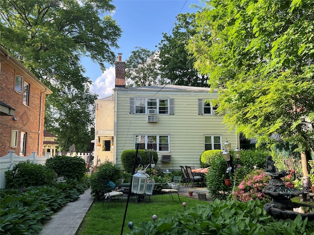 196-19 42nd Rd, Flushing, NY 11358 - back of property with a chimney, a patio, and fence