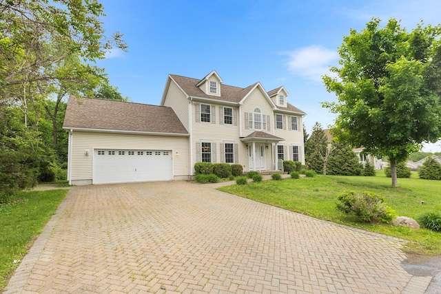 135 Ray Blvd, Poughkeepsie, NY 12603 - colonial home featuring a garage, decorative driveway, and a front lawn