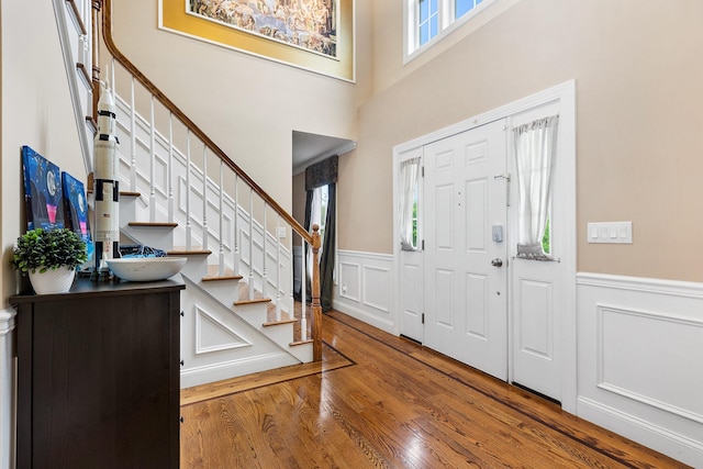 135 Ray Blvd, Poughkeepsie, NY 12603 - entrance foyer with a wainscoted wall, stairs, wood finished floors, and a decorative wall