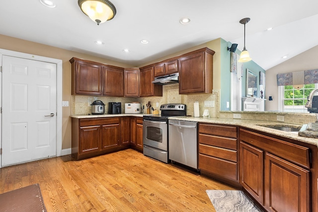 135 Ray Blvd, Poughkeepsie, NY 12603 - kitchen featuring stainless steel appliances, under cabinet range hood, tasteful backsplash, a sink, and light wood-style flooring